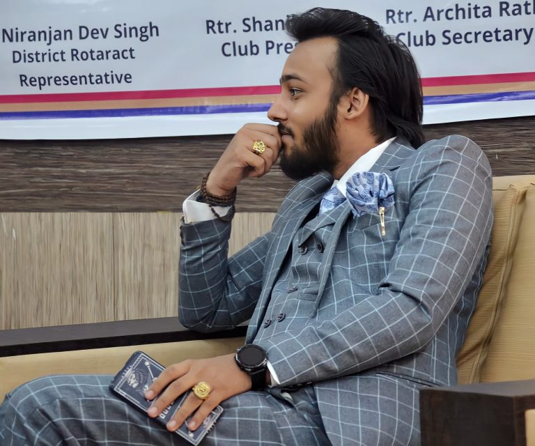 Niranjan Dev Singh Side Profile Smiling Light Grey Suit